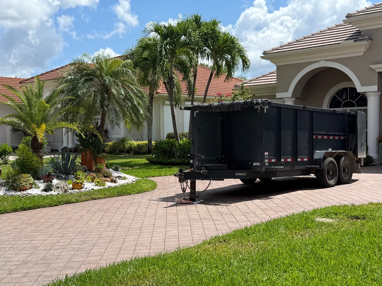a black trailer in front of a house